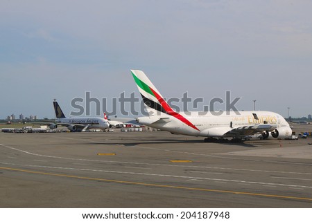 NEW YORK -JULY 10: Emirates Airline and Singapore Airlines Airbus A380 jets at JFK Airport  in NY on July 10, 2014. The Airbus A380 is a double-deck, wide-body, world\'s largest passenger airliner