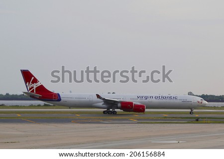 NEW YORK - JULY 10: Virgin Atlantic Airbus A340 taxing in JFK Airport in NY on July 10, 2014. JFK Airport is one of the biggest and most busy airports in the world with 4 runways and 8 terminals