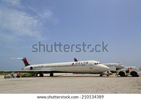 GRAND CAYMAN, CAYMAN ISLANDS - June 13  Delta Airlines McDonnell Douglas MD-80 and US Airways jet at Owen Roberts International Airport at Grand Cayman on June 13, 2014