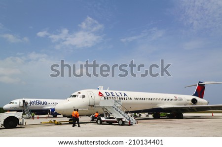 GRAND CAYMAN, CAYMAN ISLANDS - June 13  Delta Airlines McDonnell Douglas MD-80  and JetBlue Airbus A320 at Owen Roberts International Airport at Grand Cayman on June 13, 2014