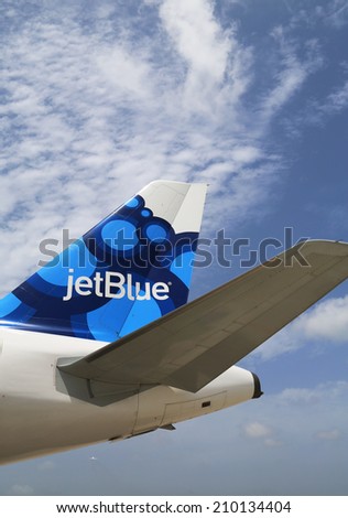GRAND CAYMAN, CAYMAN ISLANDS - June 13  JetBlue Airbus A320 blueberries-inspired design tailfin  at Owen Roberts International Airport at Grand Cayman on June 13, 2014
