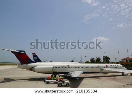 GRAND CAYMAN, CAYMAN ISLANDS - June 13  Delta Airlines McDonnell Douglas MD-80 and US Airways jet at Owen Roberts International Airport at Grand Cayman on June 13, 2014