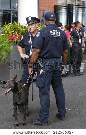 NEW YORK - AUGUST 23: NYPD transit bureau K-9 police officers and K-9 dog Sam  providing security at National Tennis Center during US Open 2014 on August 23, 2014 in New York