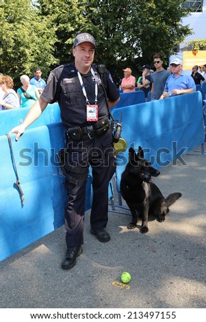 NEW YORK - AUGUST 26: NYPD transit bureau K-9 police officer and Belgian Shepherd K-9 Taylor providing security at National Tennis Center during US Open 2014 on August 26, 2014 in New York