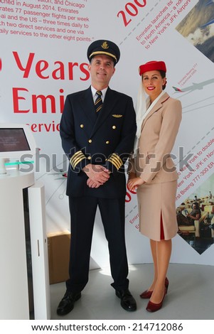 NEW YORK - SEPTEMBER 1: Emirates Airlines pilot and flight attendant at the Emirates Airlines booth at the Billie Jean King National Tennis Center during US Open 2014 on September 1, 2014 in New York