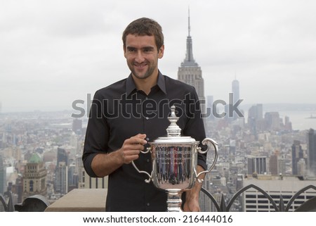 NEW YORK CITY - SEPTEMBER 9: US Open 2014 champion Marin Cilic posing with US Open trophy on the Top of the Rock Observation Deck at Rockefeller Center on September 9, 2014 in New York