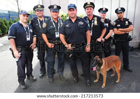 NEW YORK - SEPTEMBER 7: NYPD transit bureau K-9 police officers and K-9 dog providing security at National Tennis Center during US Open 2014 on September 7, 2014 in New York