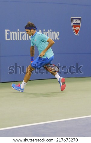 NEW YORK - AUGUST 31: Seventeen times Grand Slam champion Roger Federer using Tweener during third round match at US Open 2014 at Billie Jean King National Tennis Center on August 31, 2014 in New York