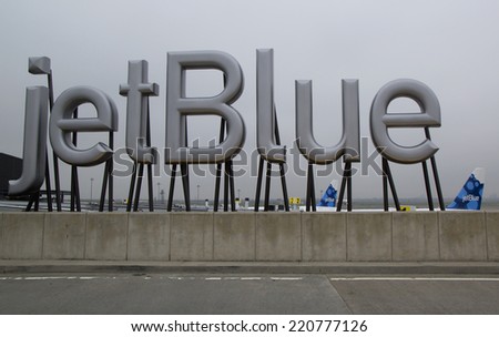 NEW YORK- MAY 8: JetBlue sign at the Terminal 5 at John F Kennedy International Airport in New York on May 8, 2014. JFK is one of the biggest airports in the world with 4 runways and 8 terminals