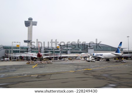 NEW YORK - MAY 8: Air Traffic Control Tower and Terminal 4 with Virgin Atlantic  and EgyptAir planes at the gates in JFK Airport in NY on May 8, 2014