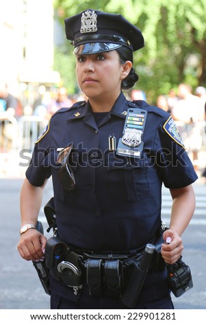 NEW YORK - June 29: NYPD officer providing security during LGBT Pride Parade in NY on June 29, 2014. LGBT pride march takes place during pride week and is the culmination of week long festivities