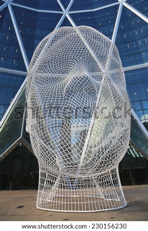 CALGARY, CANADA - JULY 29:  Wonderland sculpture by  Jaume Plensa in the front of the Bow Tower on July 29, 2014 in Calgary, Alberta, Canada. Jaume Plensa is a Catalan Spanish artist and sculptor