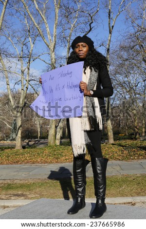 BROOKLYN, NEW YORK - DECEMBER 14: A protester holds a sign during a march   against police brutality and grand jury decision on Eric Garner case on Grand Army Plaza in Brooklyn on December 14, 2014