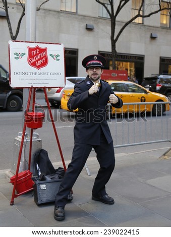 NEW YORK - DECEMBER 18: Salvation Army soldier perform for collections on December 18, 2014 in midtown Manhattan. This Christian organization is known for its charity work, operating in 126 countries