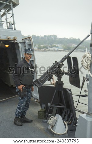 NEW YORK - MAY 22 Unidentified US Navy with .50-caliber machine gun on the deck of US guided missile destroyer USS Cole during Fleet Week 2014 on May 22, 2014 in New York