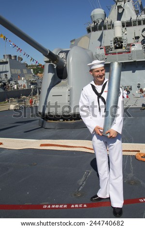 NEW YORK - MAY 25, 2014:Unidentified US Navy with gun shell in the front of turret containing a 5-inch gun on the deck of US Navy guided-missile destroyer USS McFaul during Fleet Week 2014 in New York