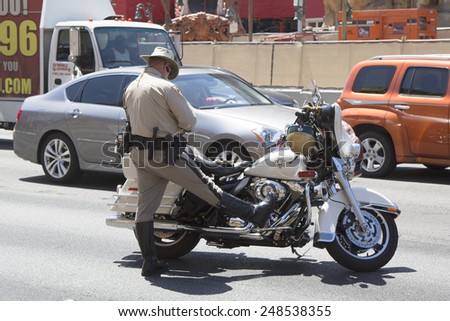 LAS VEGAS, NEVADA - MAY 9, 2014: Las Vegas Police Department officer on motorcycle on Las Vegas Strip. The Las Vegas Metropolitan Police Department is a joint city-county police force