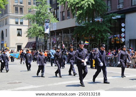 NEW YORK - JUNE 29, 2014: NYPD members at LGBT Pride Parade in New York City. LGBT pride march takes place during pride week and is the culmination of week long festivities