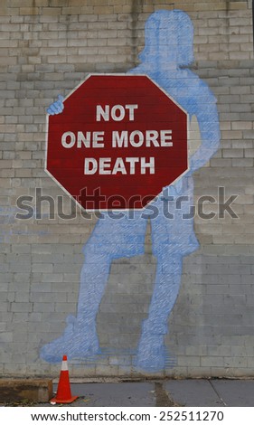 NEW YORK - NOVEMBER 13, 2014:Mural Not One More Death in Park Slope section of Brooklyn. A mural is any piece of artwork painted or applied directly on a wall, ceiling or other large permanent surface