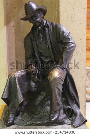 CALGARY, CANADA - JULY 26, 2014: Gold miner bronze statue in Calgary International Airport terminal
