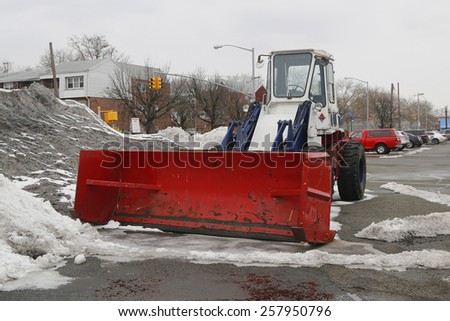 BROOKLYN, NEW YORK - MARCH 3, 2015: Tractor Snow Plow in Brooklyn, NY during record breaking winter