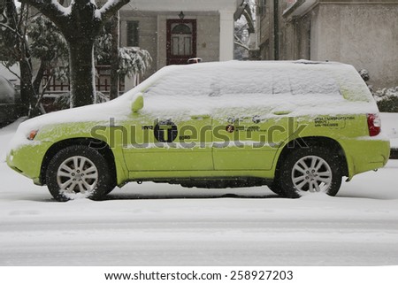 BROOKLYN, NEW YORK - MARCH 5, 2015: New York Green Boro taxi under snow in Brooklyn, NY during massive Winter Storm Thor