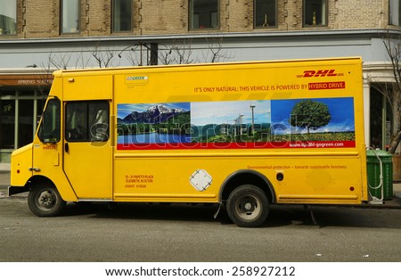 NEW YORK - FEBRUARY 26, 2015: DHL van in Lower Manhattan. DHL is a world wide courier company that operates in 220 countries with over 285,000 employees