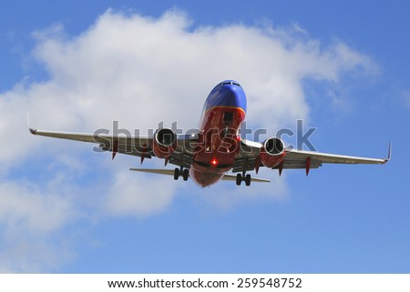 SAN DIEGO, CALIFORNIA - SEPTEMBER 27, 2014: Southwest Airlines jet descending for landing San Diego International Airport.