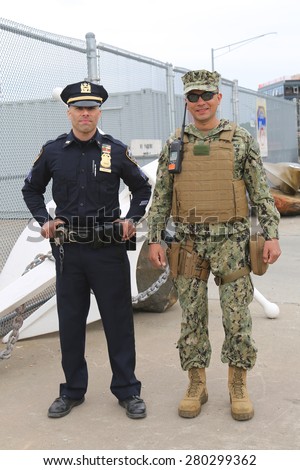 NEW YORK - MAY 20, 2015:  NYPD police officer and US Marine providing security during Fleet Week 2015 in New York