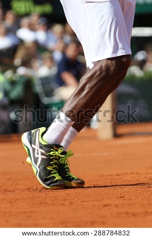 PARIS, FRANCE- MAY 27, 2015: Professional tennis player Gael Monfis wears custom Asics tennis shoes during second round match at Roland Garros 2015 in Paris, France