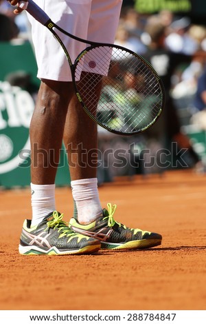 PARIS, FRANCE- MAY 27, 2015: Professional tennis player Gael Monfis wears custom Asics tennis shoes during second round match at Roland Garros 2015 in Paris, France