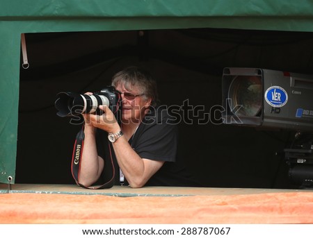 PARIS, FRANCE- MAY 29, 2015: Professional sport  photographer during match at Roland Garros 2015 in Paris, France