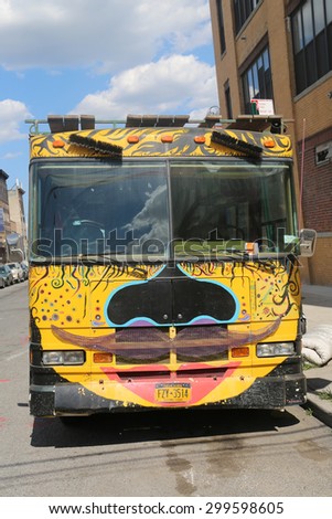 NEW YORK - JULY 23, 2015: Bus covered with graffiti in Brooklyn. Outdoor art gallery known as the Bushwick Collective has most diverse collection of street art in Brooklyn
