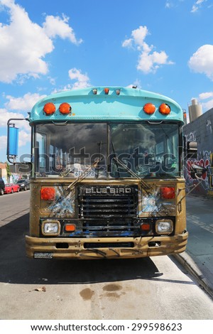 NEW YORK - JULY 23, 2015: Bus covered with graffiti in Brooklyn. Outdoor art gallery known as the Bushwick Collective has most diverse collection of street art in Brooklyn