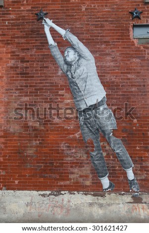 NEW YORK - JUNE 30, 2015: Stencil art in Red Hook section of Brooklyn. A mural is any piece of artwork painted or applied directly on a wall, ceiling or other large permanent surface