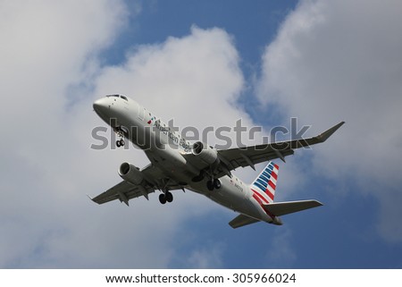 NEW YORK - AUGUST 13, 2015: American Eagle Embraer ERJ-145 jet descending for landing at JFK International Airport in New York