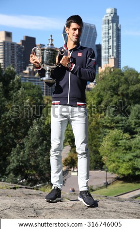 NEW YORK - SEPTEMBER 14, 2015: Ten times Grand Slam champion Novak Djokovic posing in Central Park with championship trophy after victory at US Open 2015