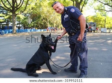 NEW YORK - SEPTEMBER 5, 2015: NYPD transit bureau K-9 police officer and German Shepherd K-9 providing security at National Tennis Center during US Open 2015 in New York