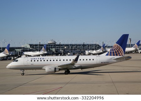 CHICAGO, ILLINOIS - OCTOBER 25, 2015: United Express Embraer plane on tarmac at O\'Hare International Airport in Chicago