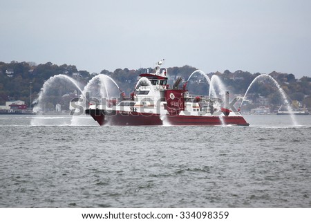 NEW YORK - NOVEMBER 2, 2015: FDNY fire boat sprays water into the air to celebrate the start of New York City Marathon 2015 in New York Harbor