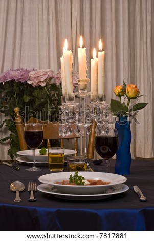 Romantic table for two served with Russian soup Borscht.
