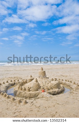 Sandcastle on the beach. Sea on the background
