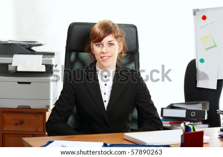 Pretty redhaired business lady or student working at a desk
