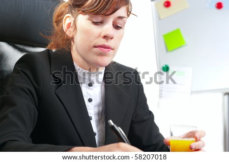 Pretty redhaired business lady or student working at a desk