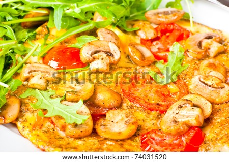 Tomato and mushroom omelette served with rocket salad.