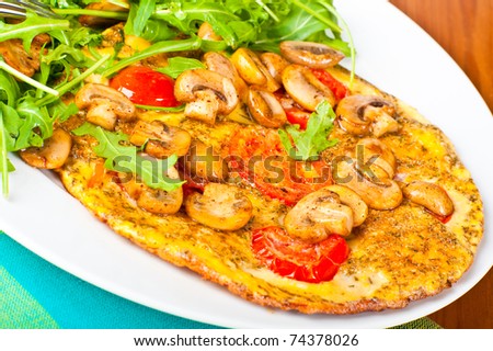 Tomato and mushroom omelette served with rocket salad.