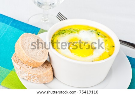Spinach baked egg served with French loaf