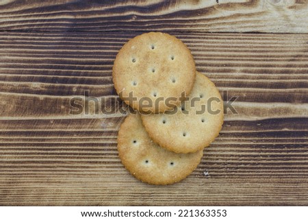Three round cookies on a wooden background