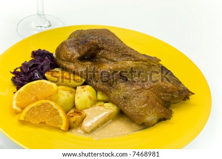 roasted duck with deep fried potatoes and red cabbage