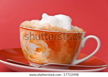 A good start to any day... fresh cappuccino-on the red background